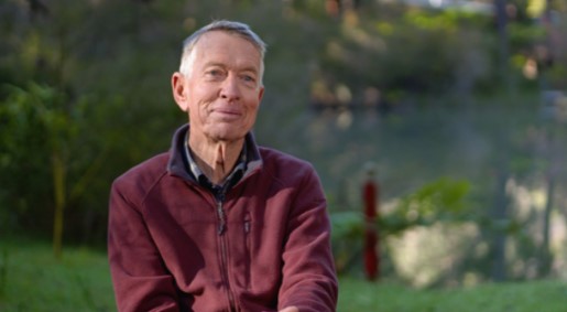 Professor Kingsley Dixon seated outdoors in a natural setting